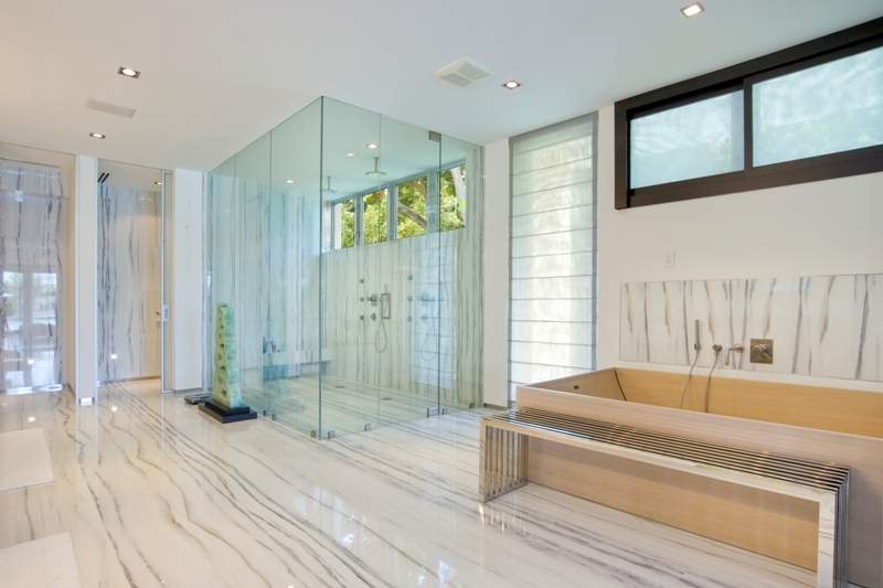 Spacious bathroom with glass shower doors and marble floors